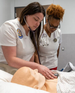 Nursing student with instructor in new simulation lab.