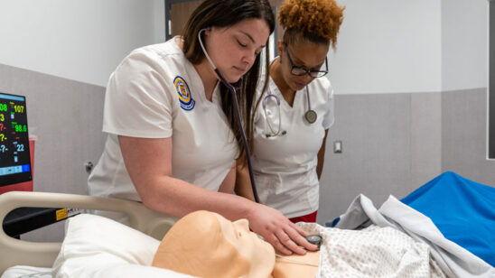 Nursing student with instructor in new simulation lab.