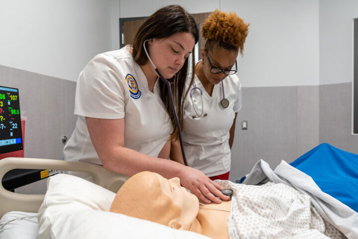 Nursing student with instructor in new simulation lab.