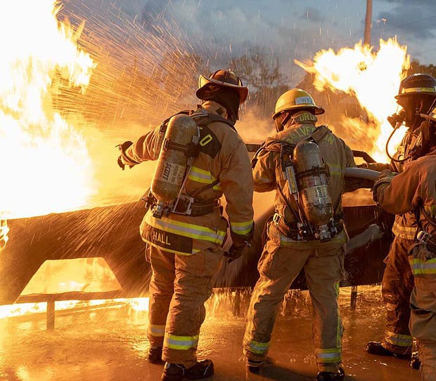 Fire Academy students putting out burning car.