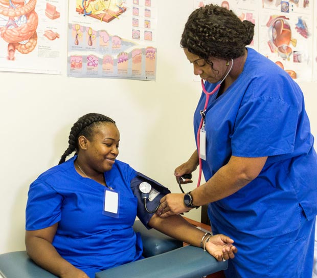 Student taking blood pressure.