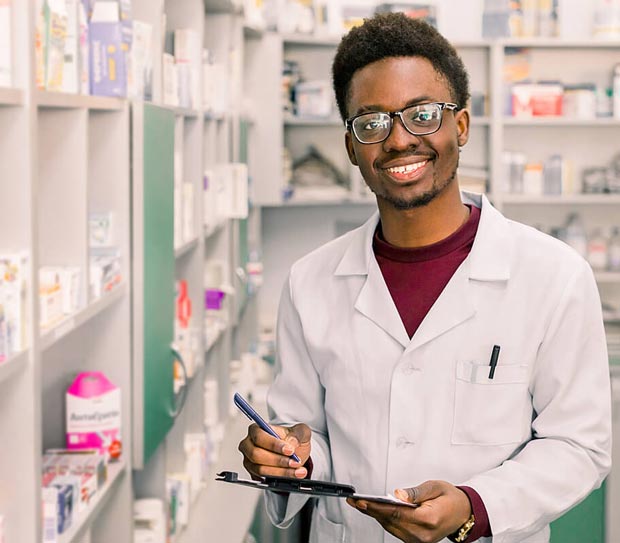 Student in pharmacy filling prescriptions.