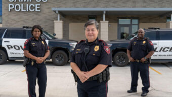 Campus Police standing outside new building.