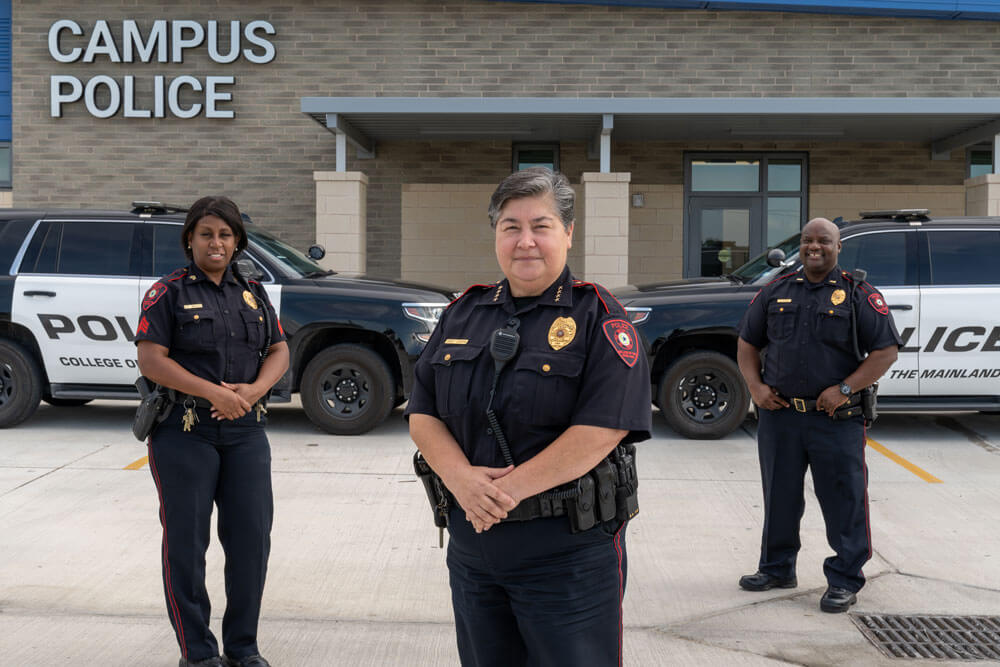 Campus Police standing outside new building.