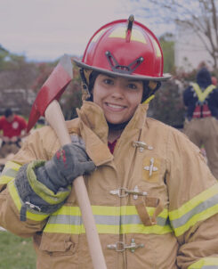 Female Firefighter in uniform with axe.