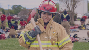 Female Firefighter in uniform with axe.