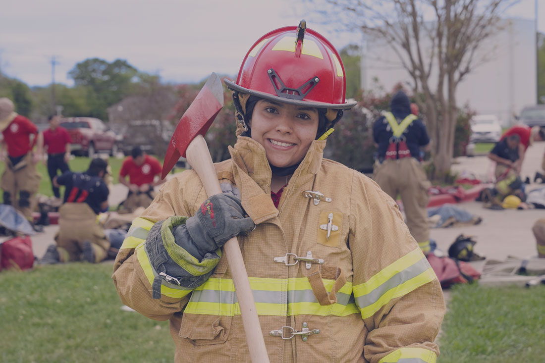 Female Firefighter in uniform with axe.