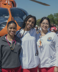 Group of students outside next to a life flight helicopter.