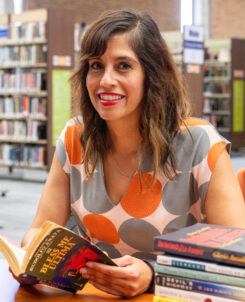 PHOTO: COM Professor Dalel Serda poses for a portrait in the library.