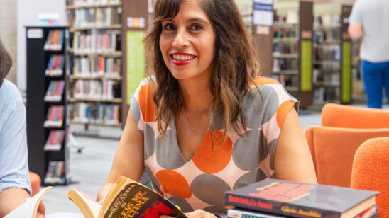 PHOTO: COM Professor Dalel Serda poses for a portrait in the library.