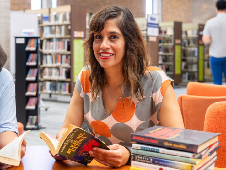 PHOTO: COM Professor Dalel Serda poses for a portrait in the library.